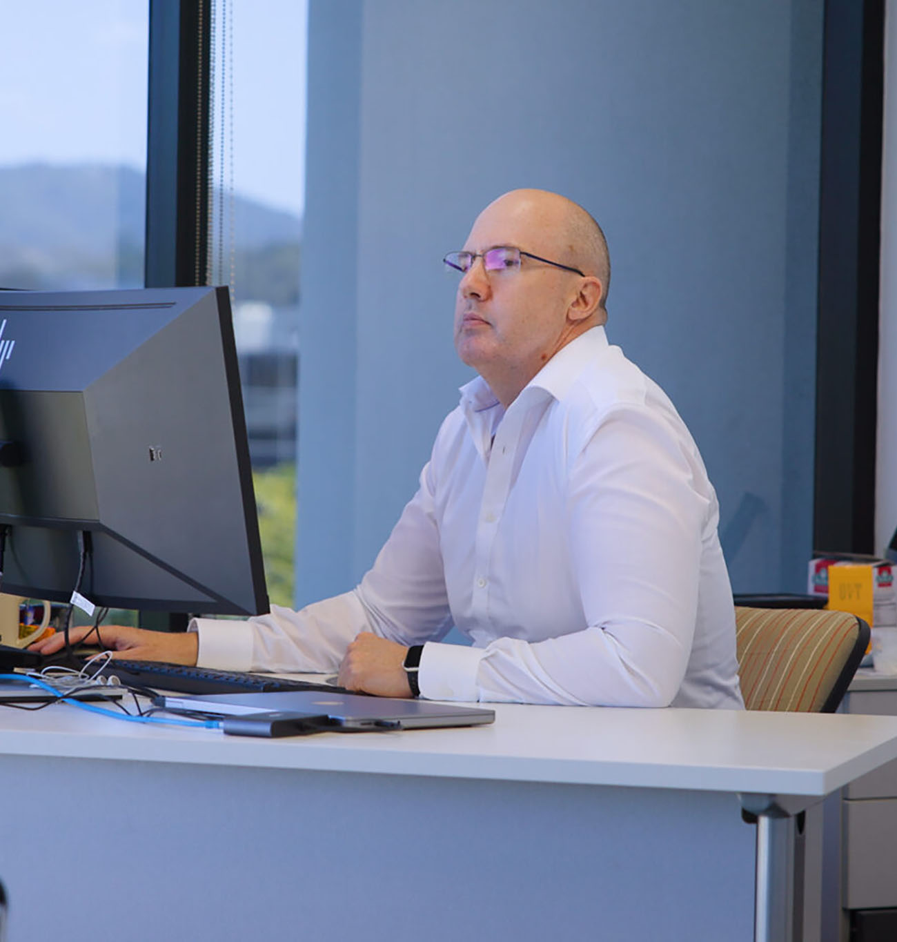 man working in an office on a laptop